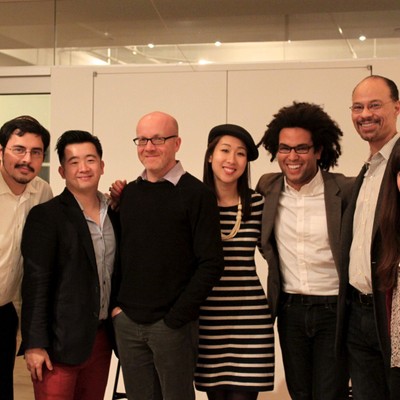 Six attendees posing together and smiling at the end of an event